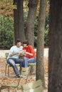 Couple Reading Guidebook In Park