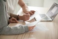 Couple holding reading documents at home with laptop, close up Royalty Free Stock Photo