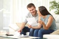 Couple reading mail at home