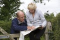 Couple reading a map in the countryside Royalty Free Stock Photo