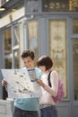 Couple Reading Map Outdoors