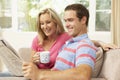 Couple Reading Newspaper At Home Royalty Free Stock Photo