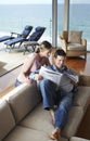 Couple Reading Newspaper In Living Room Royalty Free Stock Photo