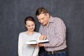 Couple is reading something interesting and amusing in book