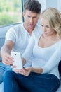 Couple reading a text message with consternation