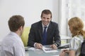 Couple With Real Estate Agent In Office Royalty Free Stock Photo