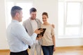 Couple and realtor with tablet pc at new home Royalty Free Stock Photo