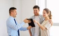 Couple and realtor with tablet pc at new home Royalty Free Stock Photo