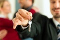 Couple receiving keys from real estate broker Royalty Free Stock Photo