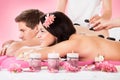 Couple Receiving Massage With Herbal Compress Stamps At Spa Royalty Free Stock Photo