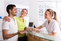 Couple with receptionist at clinic