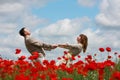 Couple on red poppies field Royalty Free Stock Photo