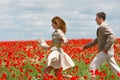 Couple on red poppies field Royalty Free Stock Photo