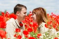 Couple on red poppies field Royalty Free Stock Photo