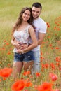 Couple in red poppies Royalty Free Stock Photo