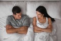 Couple with relationship problems in bed at home, top view Royalty Free Stock Photo