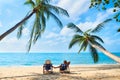 Couple relax on the beach enjoying beautiful sea on the tropical island Royalty Free Stock Photo