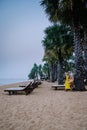 Couple relax on the beach in Pattaya Thailand Jomtien beach with beach clubs and restaurants
