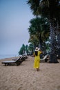 Couple relax on the beach in Pattaya Thailand Jomtien beach with beach clubs and restaurants