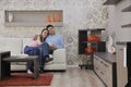 Couple relax at home on sofa in living room