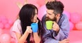 Couple relax in morning with coffee. Weekend morning concept. Man and woman in domestic clothes, pajamas. Man and woman