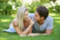 Couple, relax in park and smile with love and commitment in healthy relationship. People on grass on date outdoor, nose