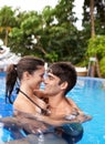 Couple, relax in pool and hug outdoor, love and connection with summer vacation at resort or hotel. Happy people Royalty Free Stock Photo