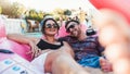Couple, relax and smile for pool party on inflatable floating in the water enjoying summer vacation together. Happy man Royalty Free Stock Photo