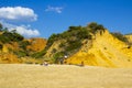 A couple relax and sunbath on a beautiful beach in Portugal