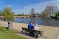 A couple relaxing by the Avon River