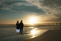 Couple relaxing on the beautiful beach at sunrise. Royalty Free Stock Photo