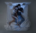 Couple watching tv in bed
