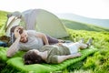 Couple relaxing at the campsite in the mountains Royalty Free Stock Photo