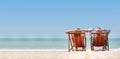 Couple relaxing on chair beach over sea background