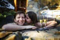 Couple Relaxing with champagne In Hot Tub Jacuzzi Outdoor. Honeymoon Couple Relaxing Together.