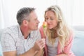 Couple relaxing on the couch with girl smelling flower