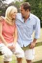 Couple Relaxing In Countryside Sitting On Fence Royalty Free Stock Photo