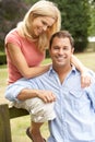 Couple Relaxing In Countryside Sitting On Fence Royalty Free Stock Photo