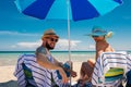 Couple relaxing on a deck chairs on a beach Royalty Free Stock Photo