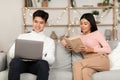 Couple Relaxing Enjoying Weekend Reading Book And Using Laptop Indoor Royalty Free Stock Photo