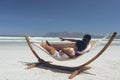 Couple relaxing on hammock at beach