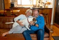 Couple relaxing at home and loving their pet. Positive image of life at home and New Normal Royalty Free Stock Photo