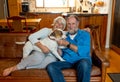 Couple relaxing at home and loving their pet. Positive image of life at home and New Normal Royalty Free Stock Photo