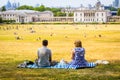 A couple relaxing on a hot, sunny day on Primrose Hill in London, UK