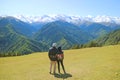 Couple Relaxing on the Meadow of Highland Farm Enjoying Fantastic View of Caucasus Mountain Ranges, Mestia, Georgia