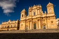 Couple relaxing on the monumental staircase at Noto cathedral, Sicily, Italy