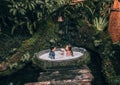 Couple relaxing in outdoor bath with tropical jungle  luxury spa hotel, lifestyle Royalty Free Stock Photo