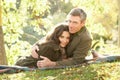 Couple Relaxing Outdoors In Autumn Landscape