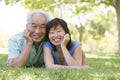 Couple relaxing outdoors in park smiling