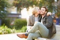 Couple Relaxing On Park Bench With Takeaway Coffee Royalty Free Stock Photo